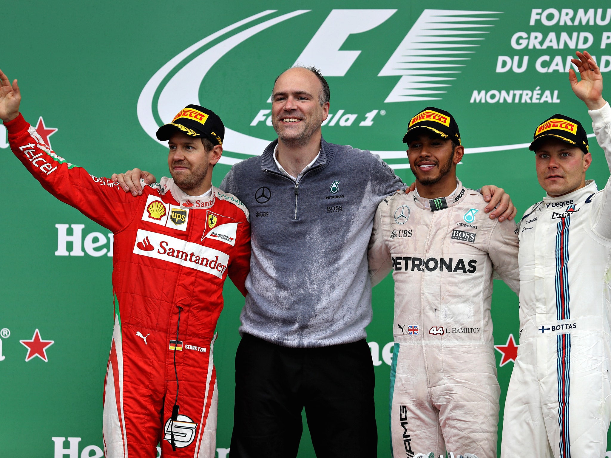 &#13;
Hamilton celebrates on the podium alongside Vettel (left) and Bottas (right) &#13;