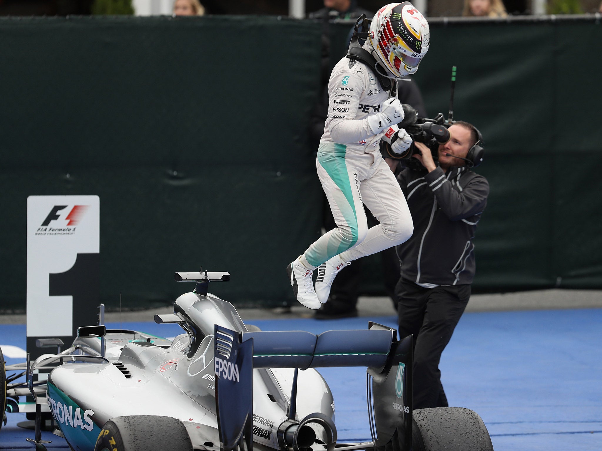 &#13;
Hamilton leaps off his Mercedes in celebration after winning in Canada &#13;