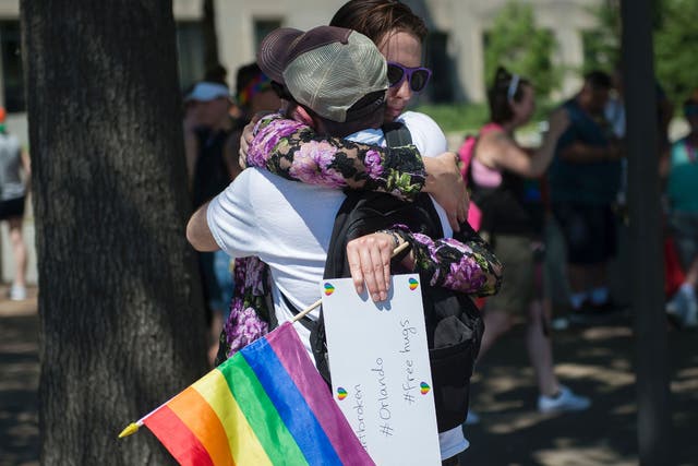 A woman offers free hugs in Washington in reaction to the mass shootings at Pulse