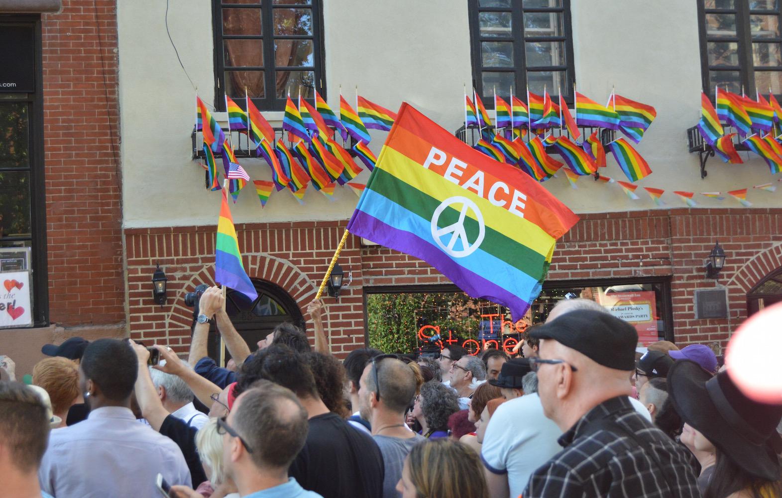 New Yorkers mourn the victims of the Orlando nightclub shooting outside Stonewall Inn.