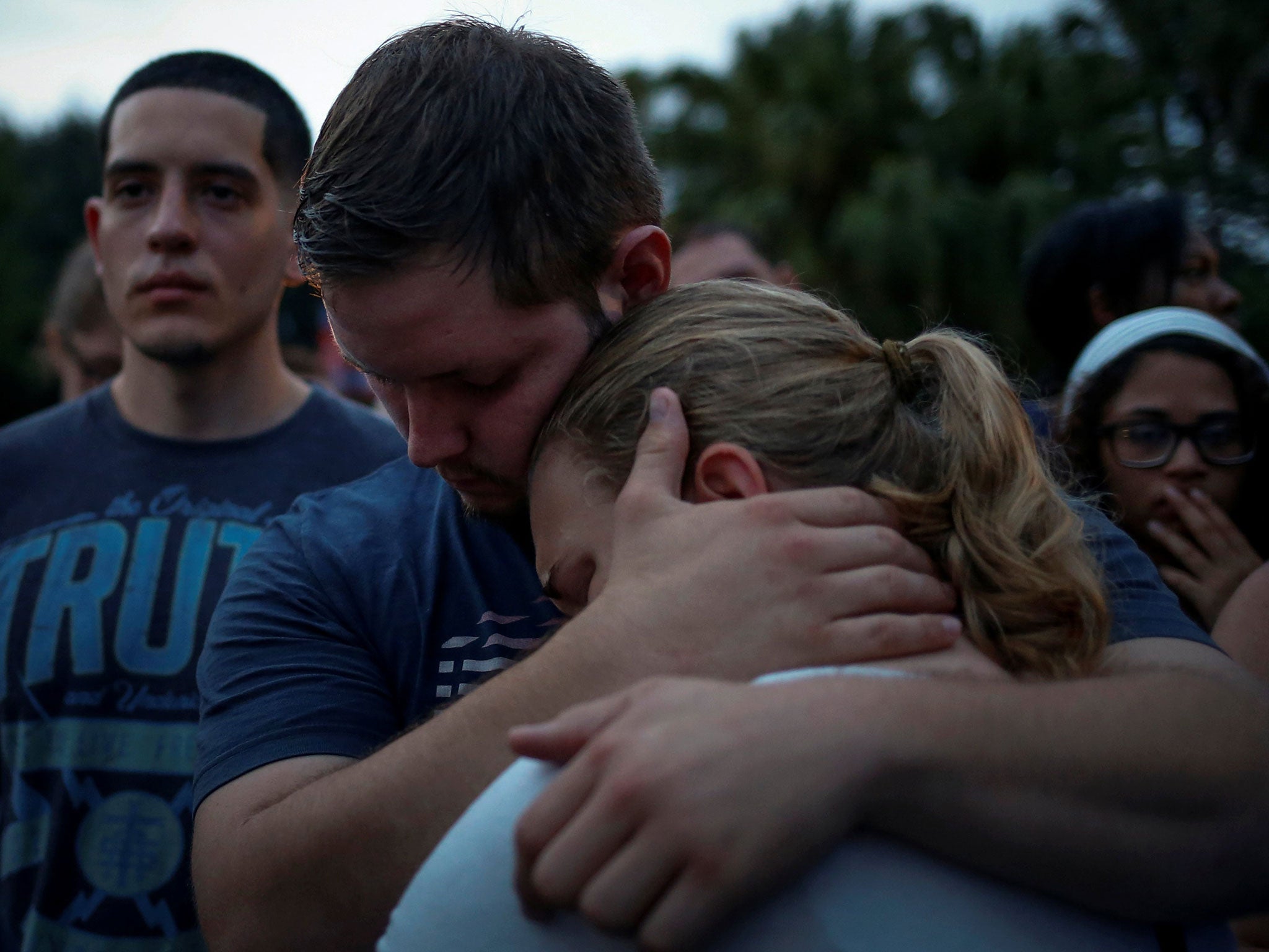Savannah is embraced by her friend Ricky during a vigil to commemorate victims of a mass shooting at the Pulse gay night club in Orlando, Florida, June 12, 2016. Savannah said she lost a friend in the shooting