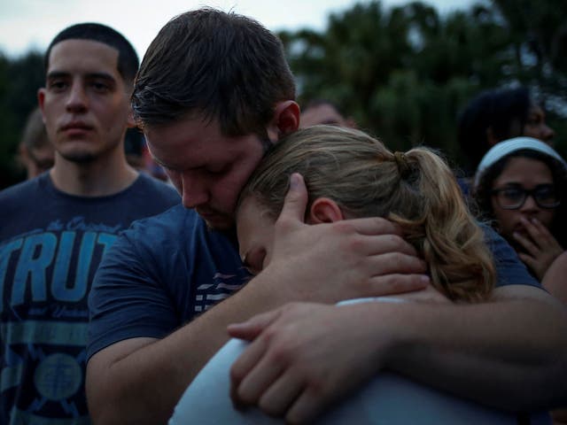 Savannah is embraced by her friend Ricky during a vigil to commemorate victims of a mass shooting at the Pulse gay night club in Orlando, Florida, June 12, 2016. Savannah said she lost a friend in the shooting