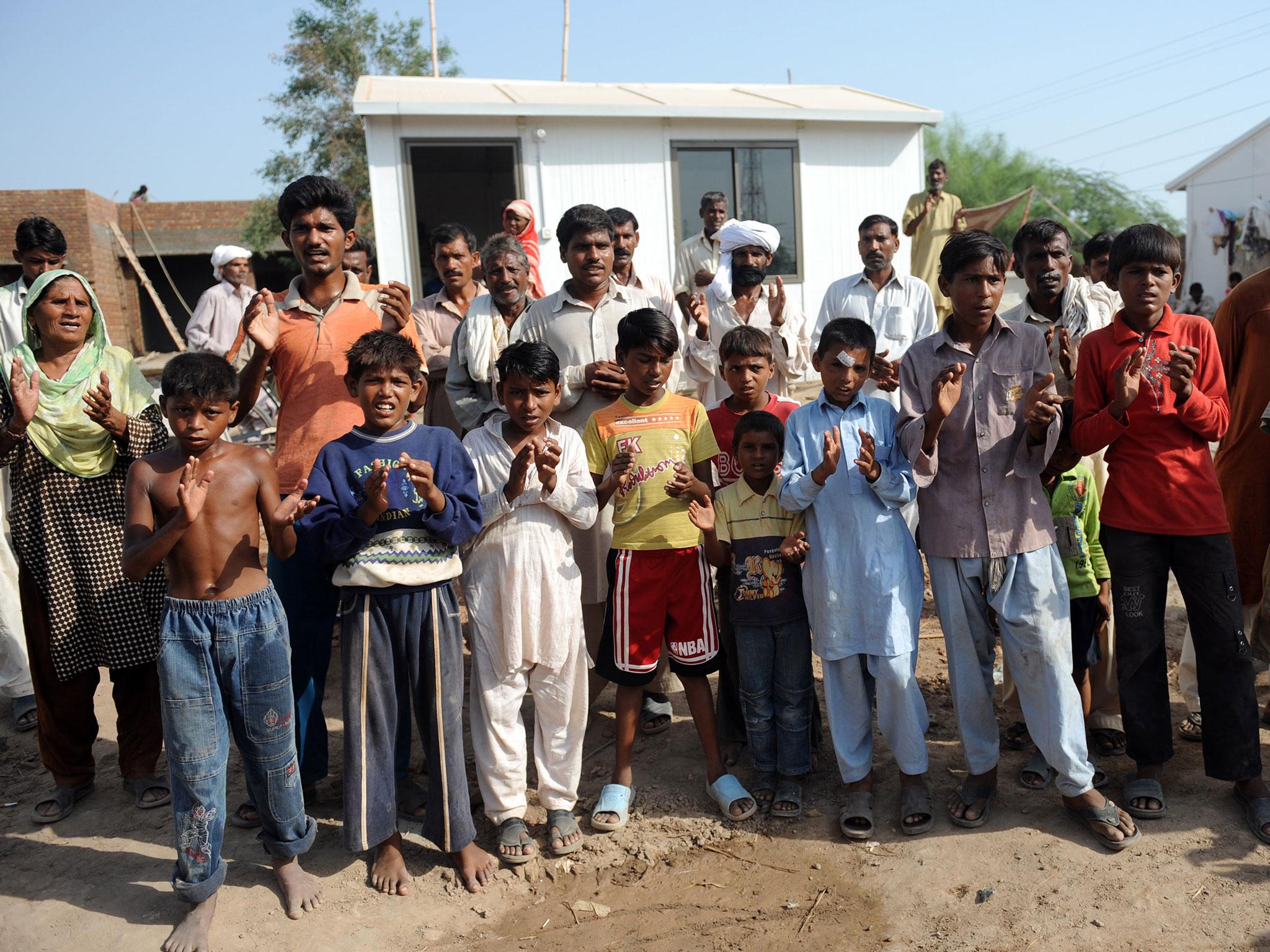 Pakistani Christians pictured praying outside homes under construction in Gojra