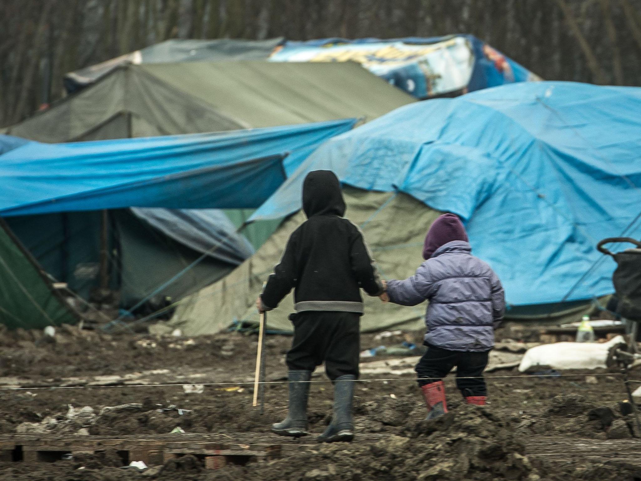 Children walk through the migrants camp of Grande-Synthe, near Dunkirk