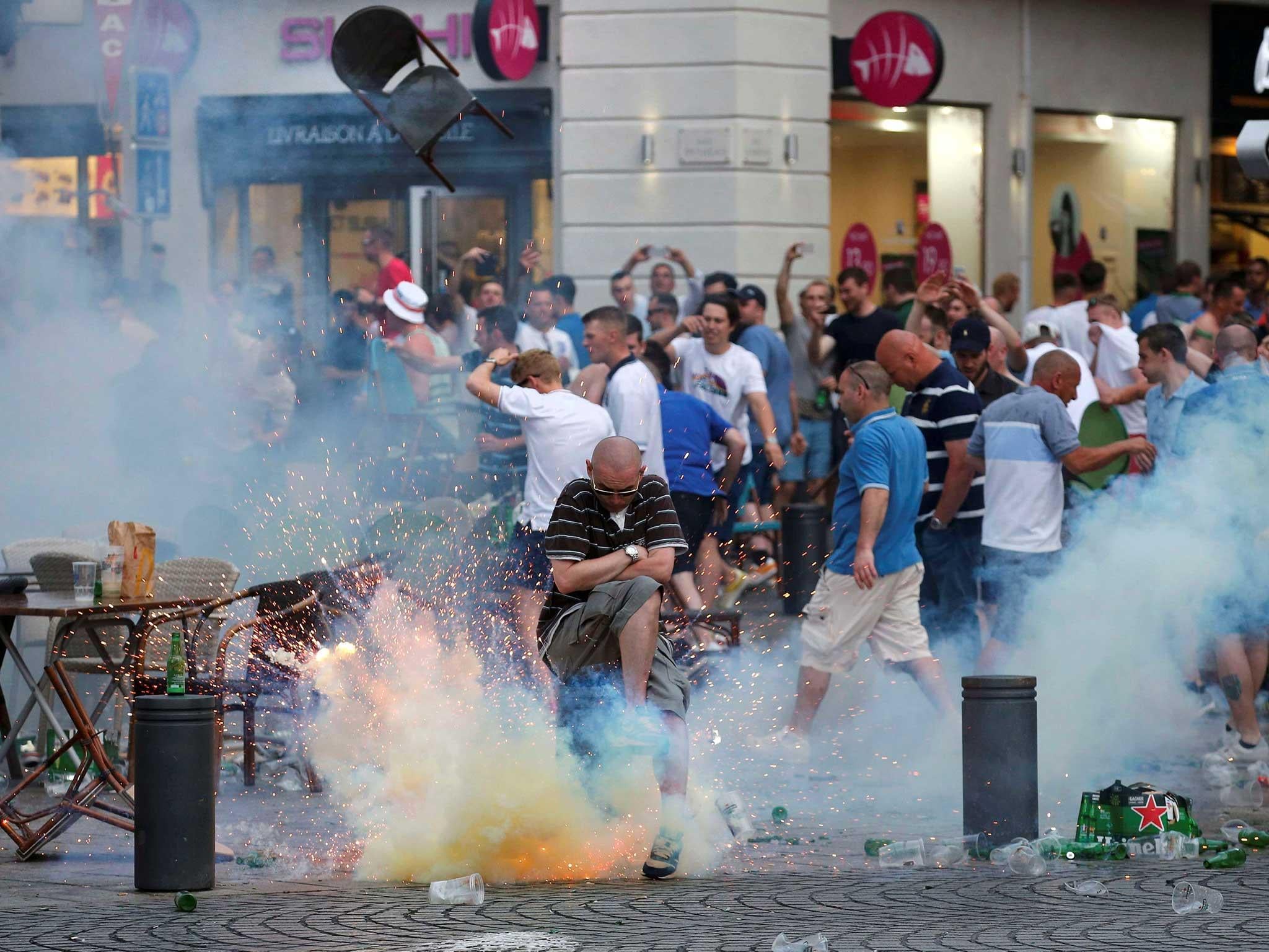 A teargas grenade explodes near an England fan ahead of England's EURO 2016 match in Marseille, as French authorities struggle to prevent violence spreading between football supporters 