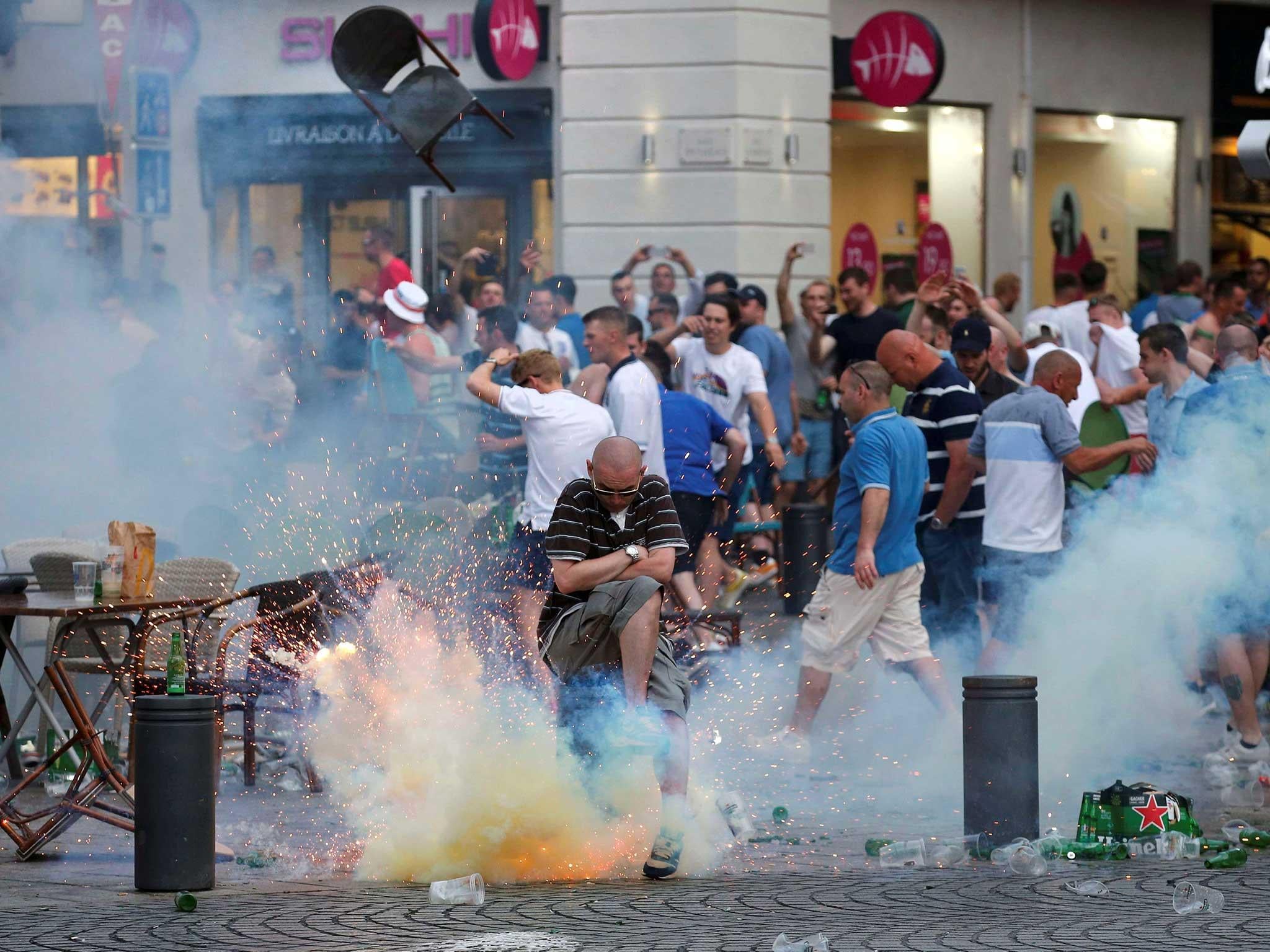 A teargas grenade explodes near an England fan ahead of England's Euro 2016 match in Marseille