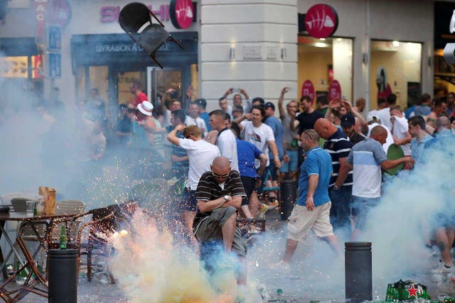 A teargas grenade explodes near an England fan ahead of England's Euro 2016 match in Marseille