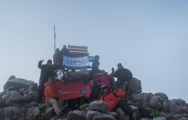 The team celebrate reaching the summit of Mt Kenya