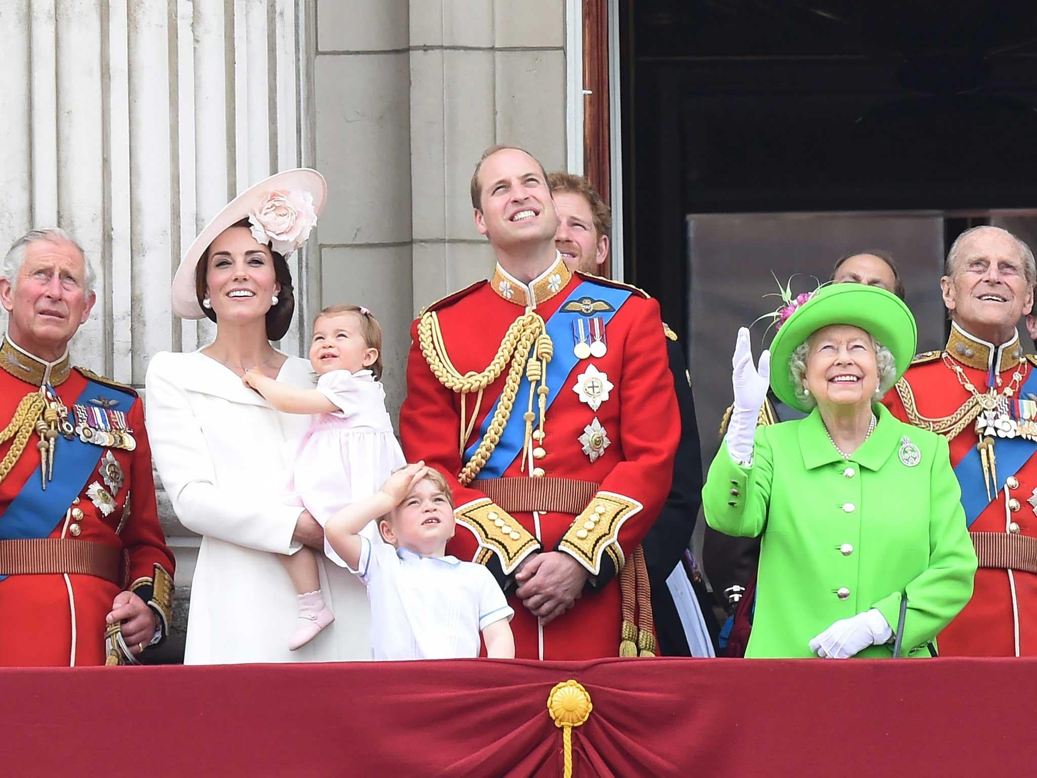 First Row (L-R) Britain's Charles, Prince of Wales, Catherine, The Duchess of Cambridge holding Princess Charlotte, Prince George, Prince William, Duke of Cambridge, Queen Elizabeth II and Prince Philip, Duke of Edinburgh look up to the sky while standing in the balcony of Buckingham Palace during the Trooping of the Color Queen's 90th birthday parade in London