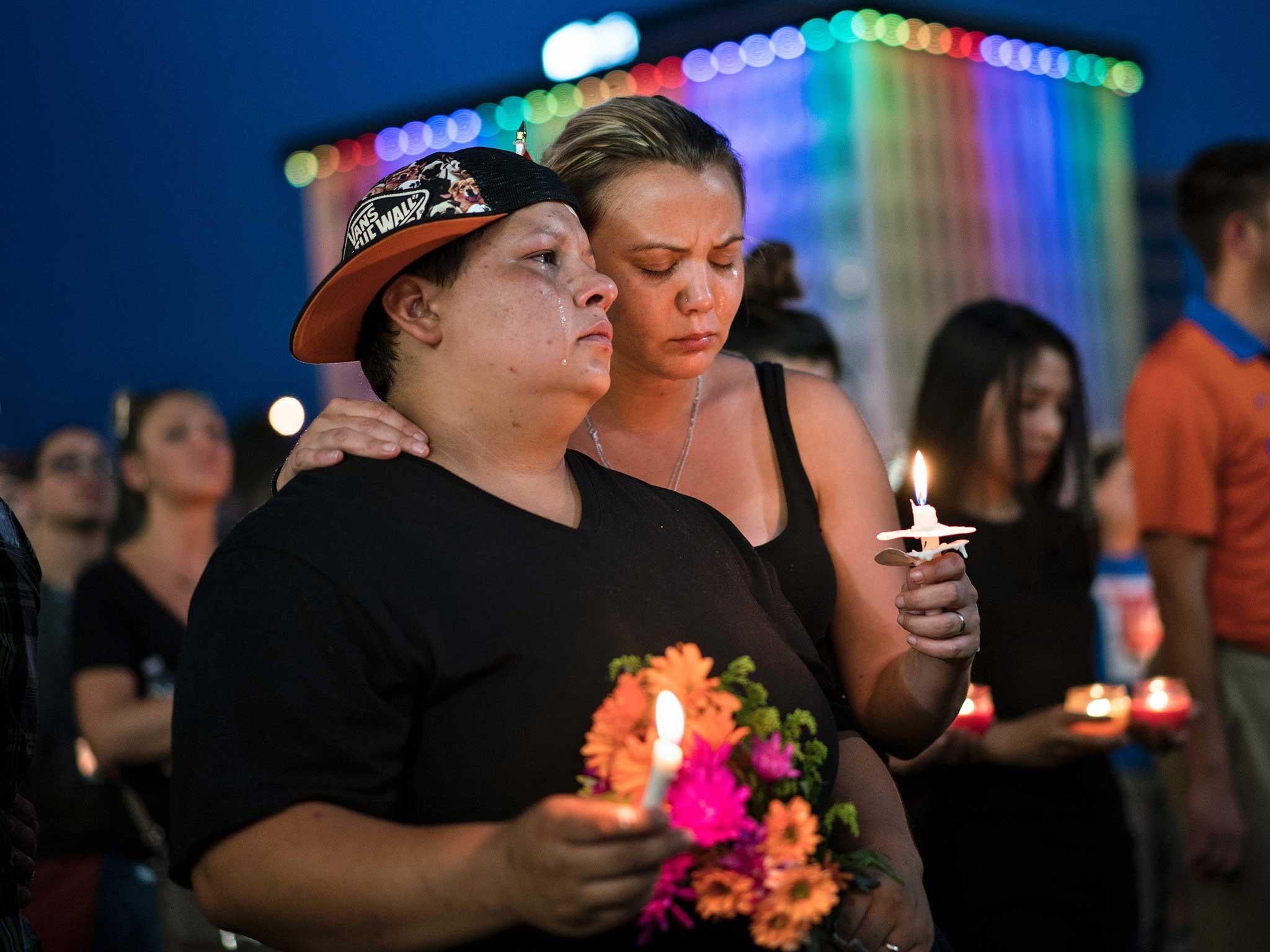 Nicole Edwards and her wife Kellie Edwards observe a moment of silence during a vigil outside the Dr. Phillips Center for the Performing Arts for the mass shooting victims at the Pulse nightclub in Orlando