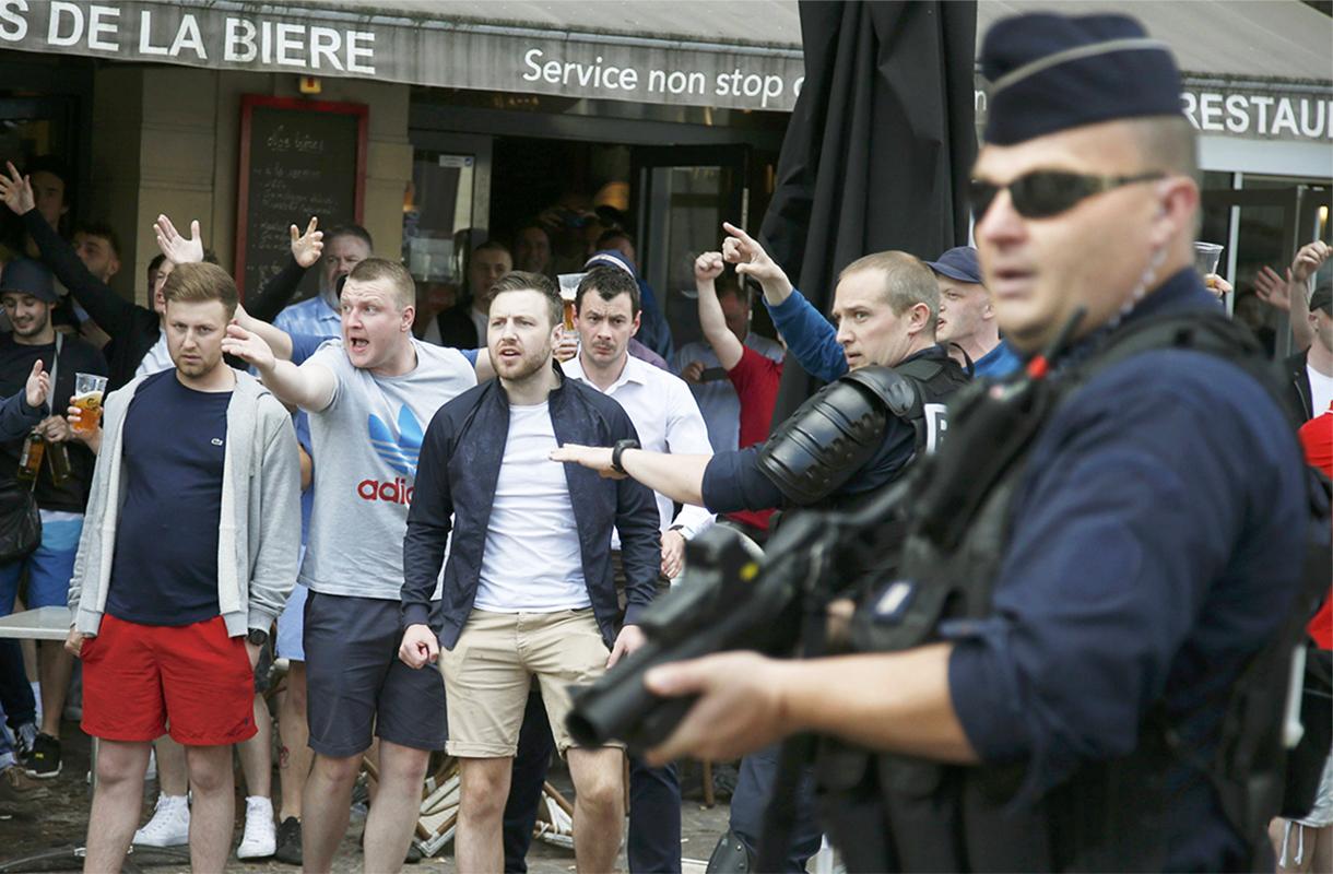 England and Wales fans react after some scuffles with Russian supporters outside a pub in Lille