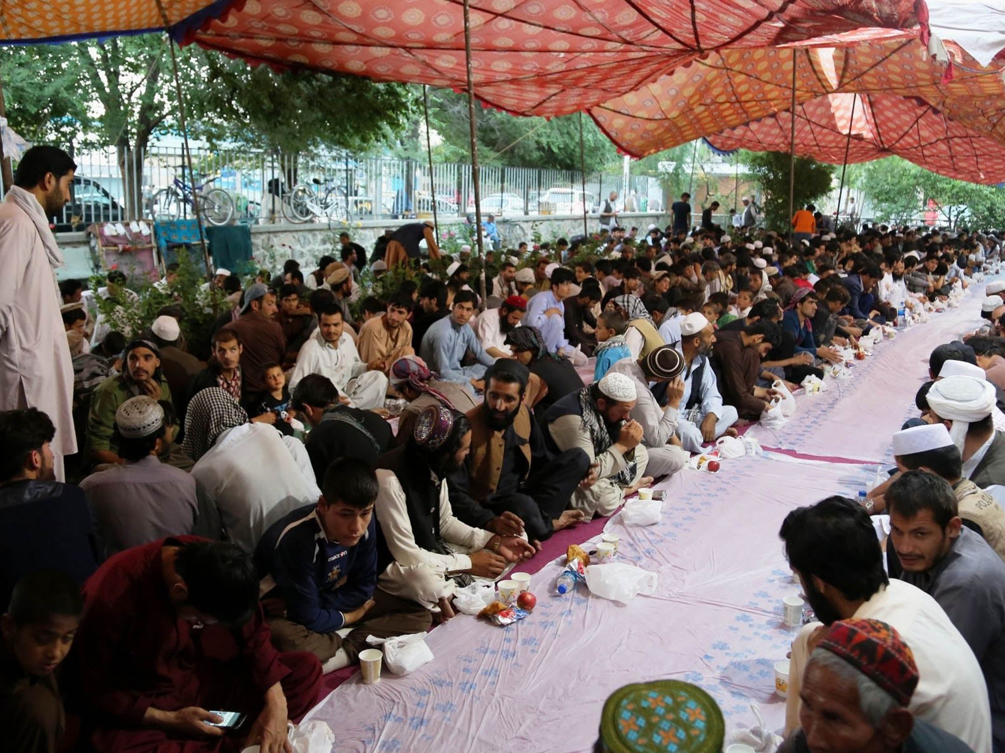People prepare to break their fast during the Ramadan at a mosque in Kabul, 13 June 2016
