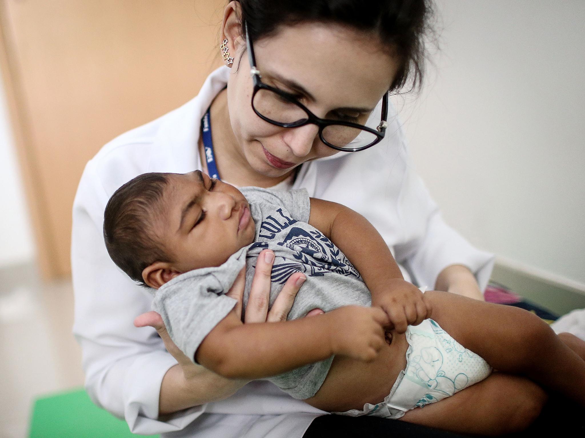 Dr Stella Guerra performs physical therapy on an infant born with microcephaly in Recife, Brazil, earlier this month