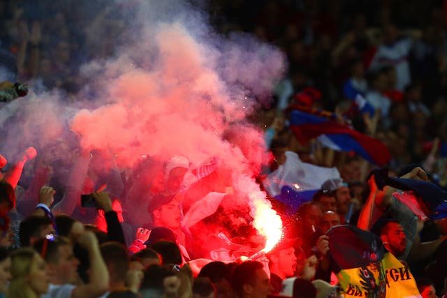 Russia fans light a flare in the Lille Metropole stands after Denis Glushikov's goal