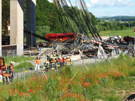 A collapsed scaffolding lies under a highway bridge near Werneck, Germany