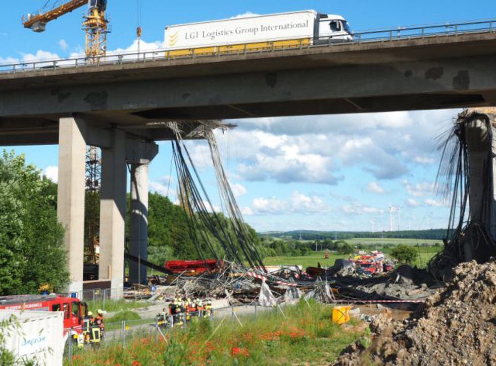 A collapsed scaffolding lies under a highway bridge near Werneck, Germany