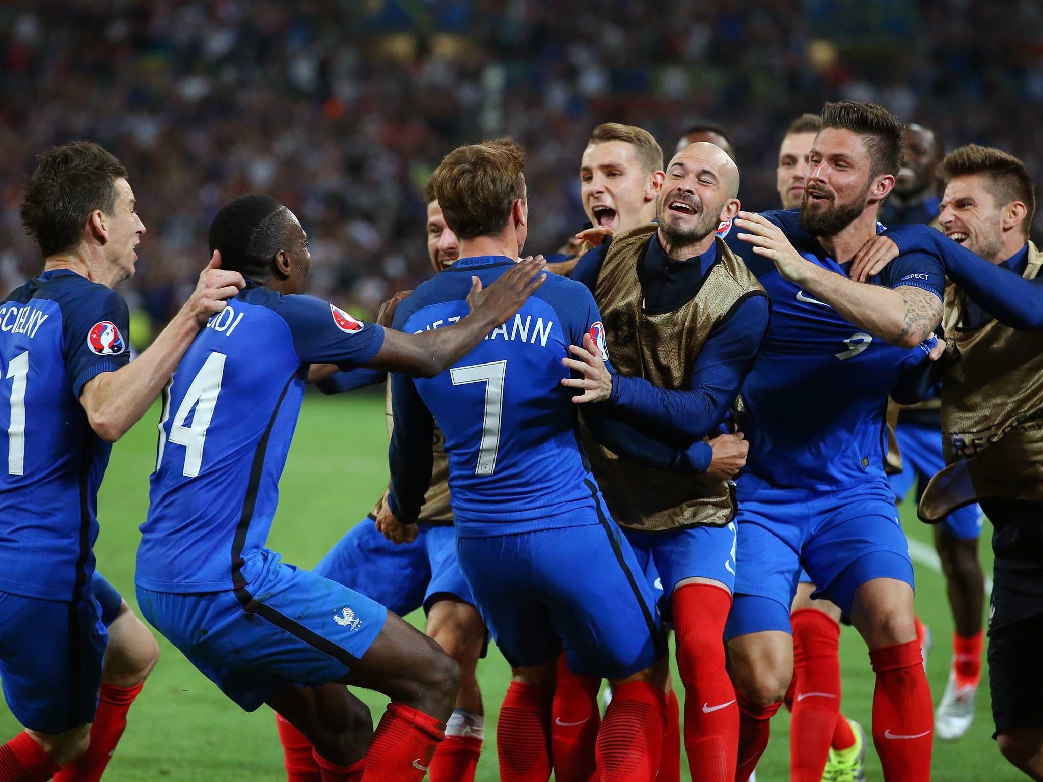 Antoine Griezmann is mobbed by his team-mates after giving France the lead