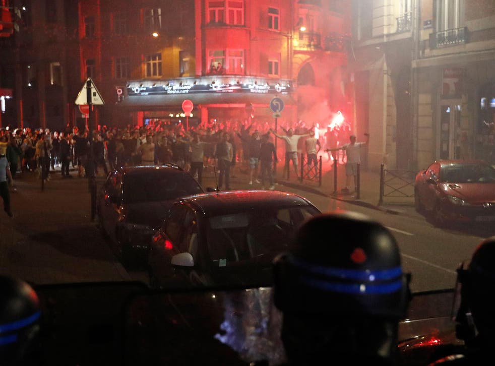 Police officers prepare to charge a group of England supporters in Lille
