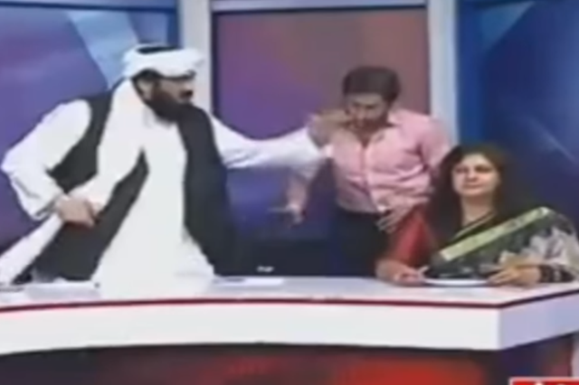 Pakistani senator Hafiz Hamdullah (left) gesticulates during a heated panel show debate about honour killings