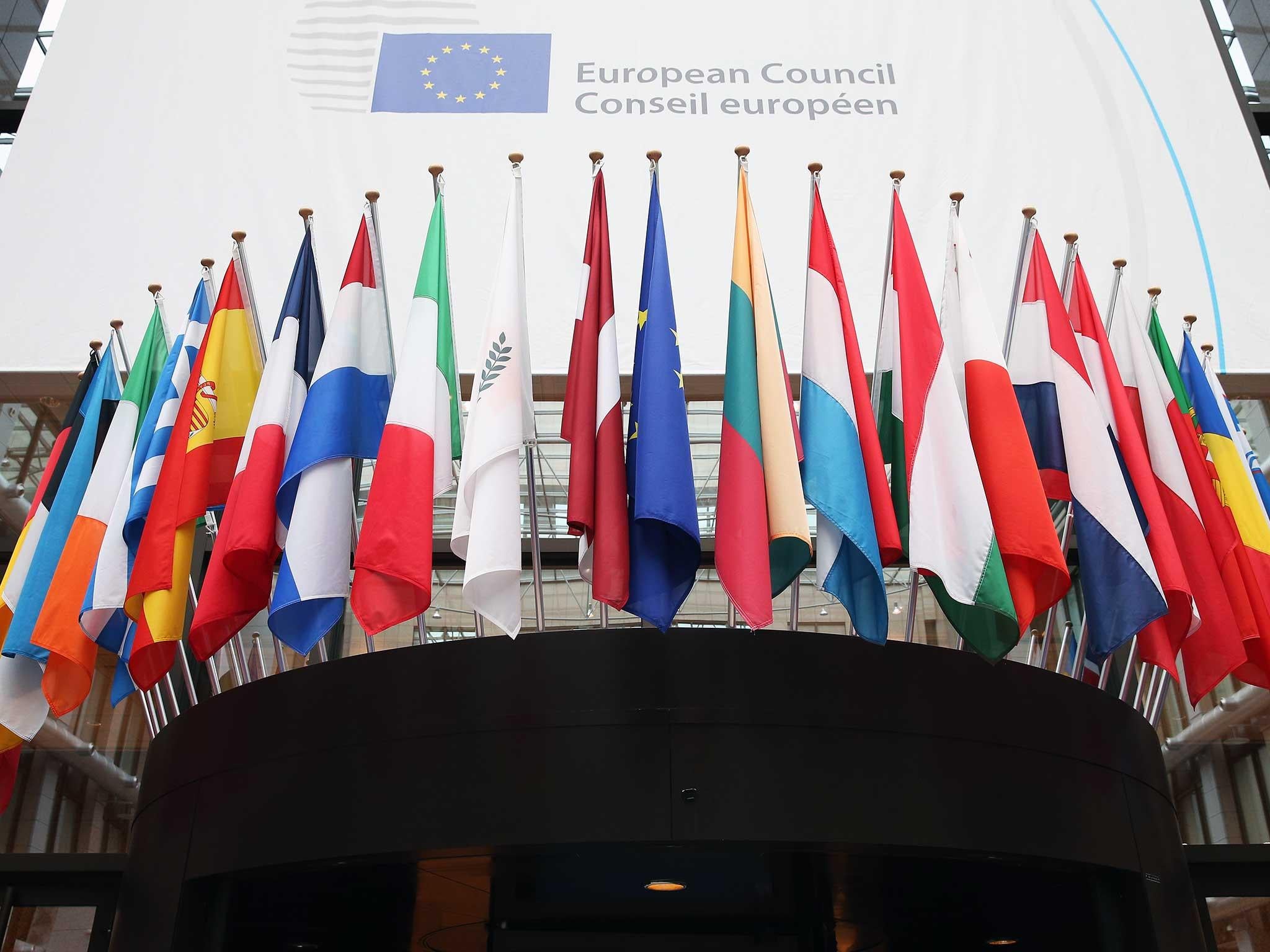 Flags of the European Union member states hang inside the Council of the European Union