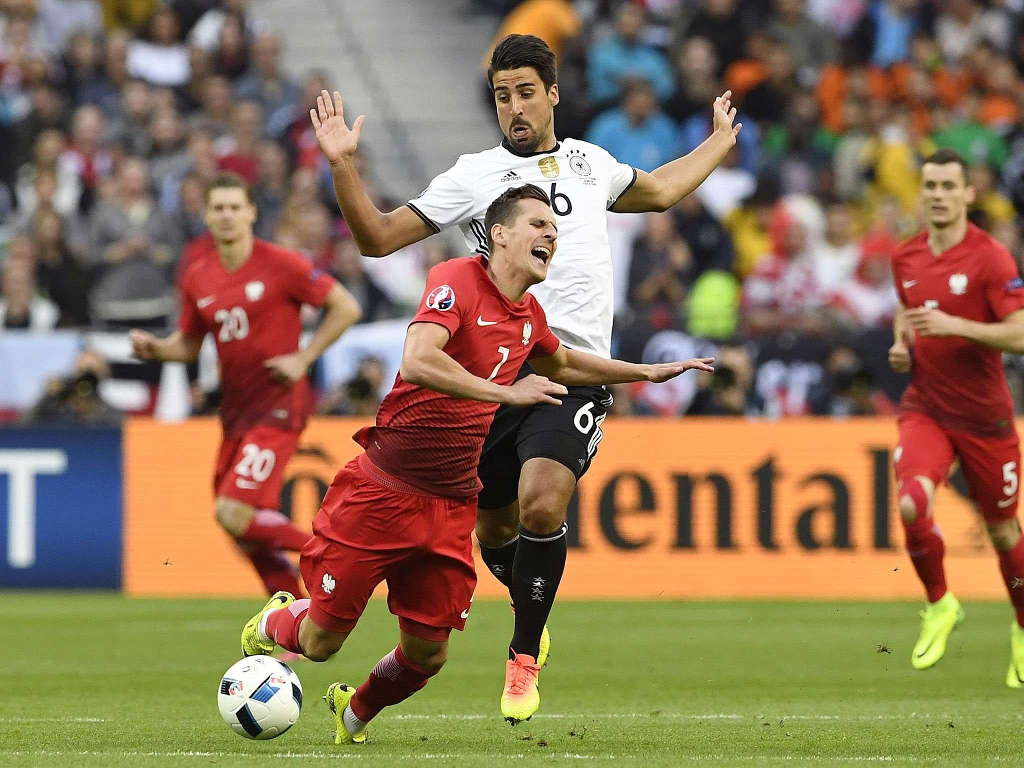 Germany's Sami Khedira (No 6) tackles Poland striker Arkadiusz Milik