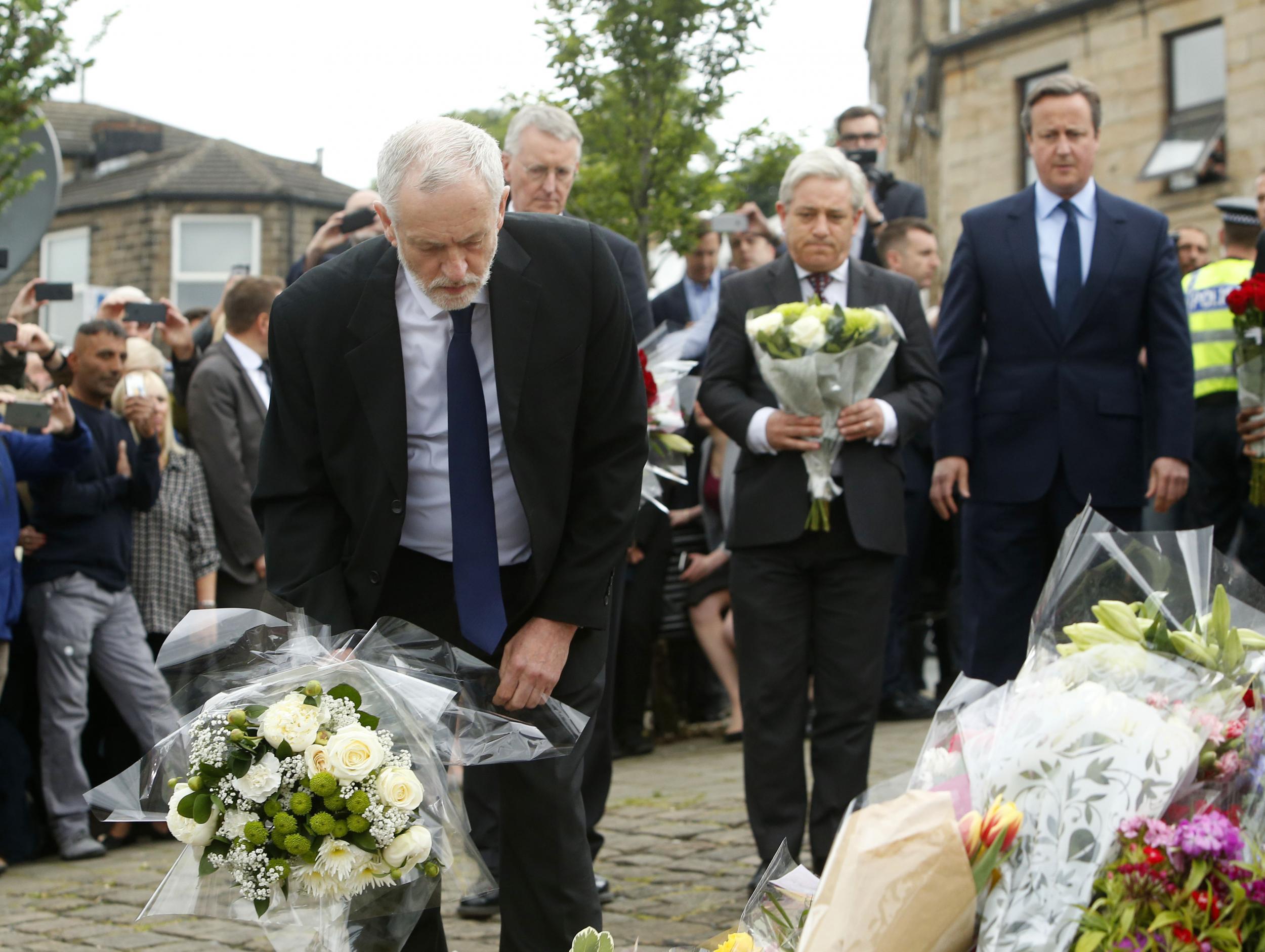 Labour Party leader Jeremy Corbyn lays flowers while Commons Speaker John Bercow and Prime Minister David Cameron look on in Birstall, West Yorkshire, after Labour MP Jo Cox was shot and stabbed to death in the street