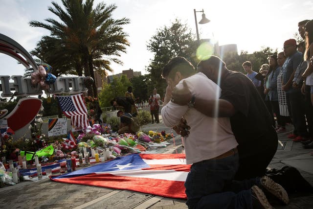 A friend of an Orlando shooting victim mourns his friend at a memorial near the Orlando Regional Medical Centre <em>Drew Angerer/Getty</em>