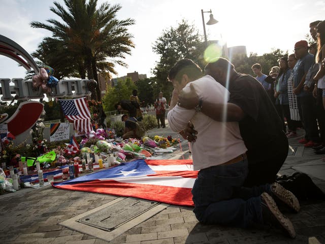 A friend of an Orlando shooting victim mourns his friend at a memorial near the Orlando Regional Medical Centre <em>Drew Angerer/Getty</em>