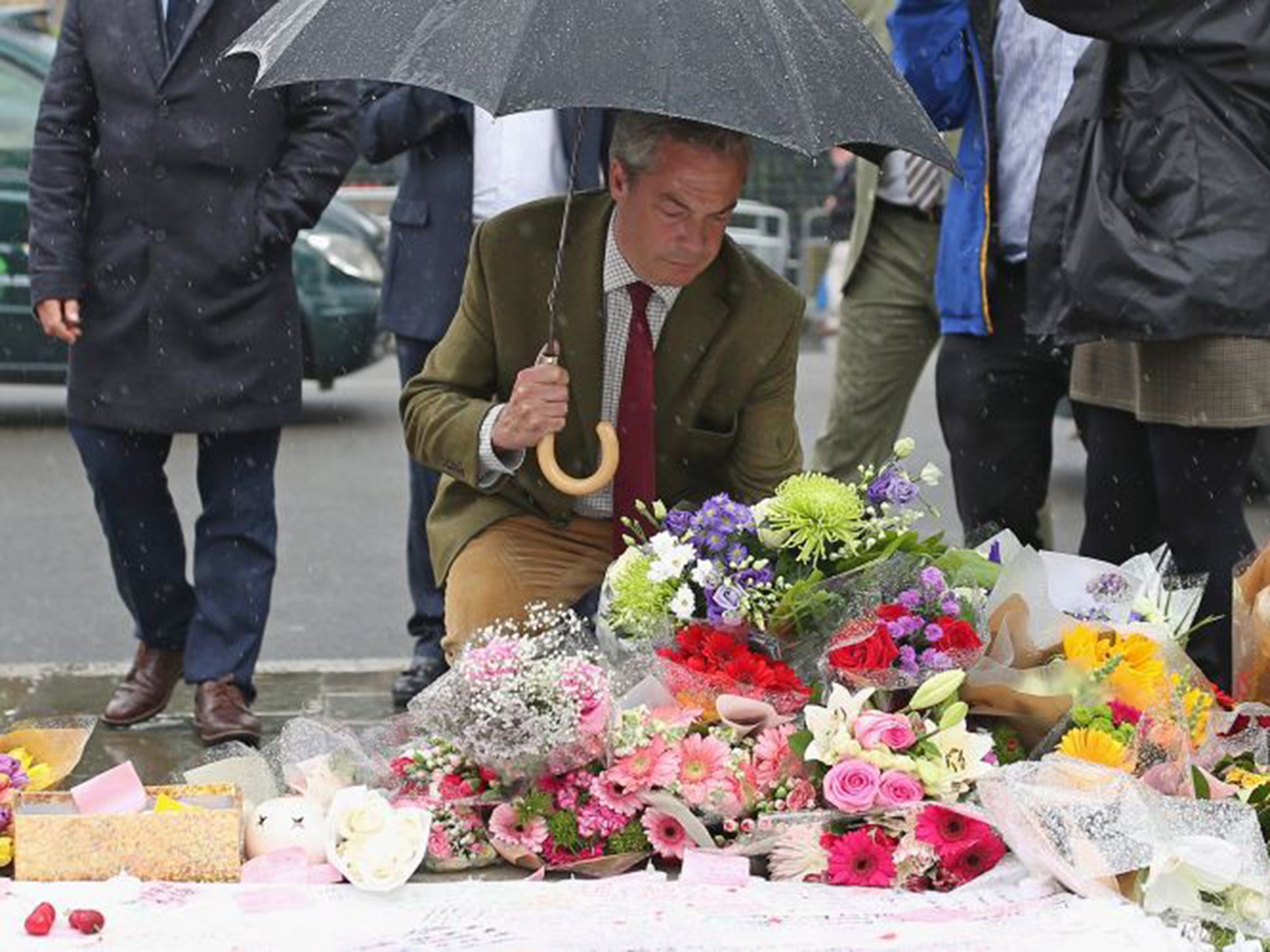 Nigel Farage leaves a floral tribute to Jo Cox in Parliament Square