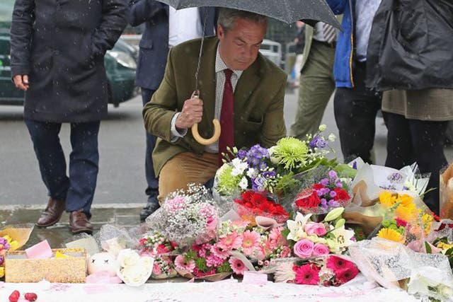 Nigel Farage leaves a floral tribute to Jo Cox in Parliament Square