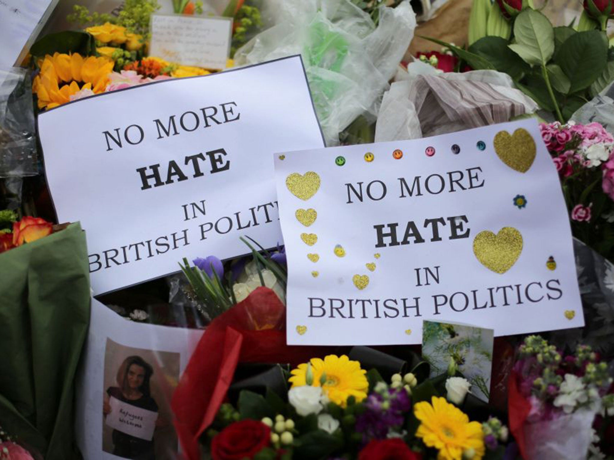 Flowers and tributes are piled in remembrance of Labour MP Jo Cox outside Parliament Square