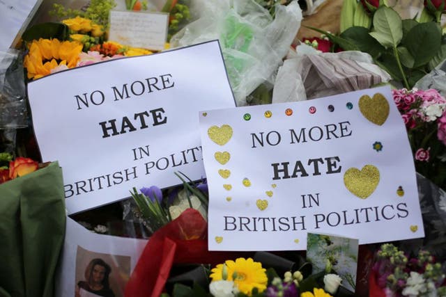 Flowers and tributes are piled in remembrance of Labour MP Jo Cox outside Parliament Square
