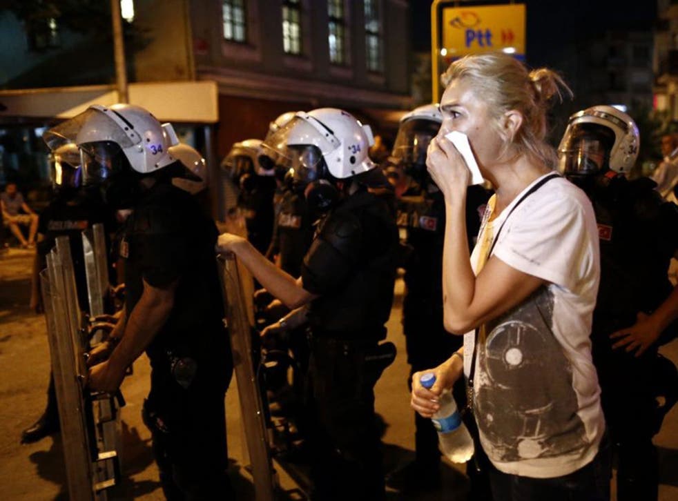 A woman covers her face while  protesters clash with Turkish riot police during an anti-government demonstration near Taksim Square, in Istanbul, Turkey, 18 June 2016. An Islamist group reportedly attacked a gathering of people who were listening to Radiohead and drinking alcohol at a record shop in Istanbul on 17 June 2016, according to media reports.