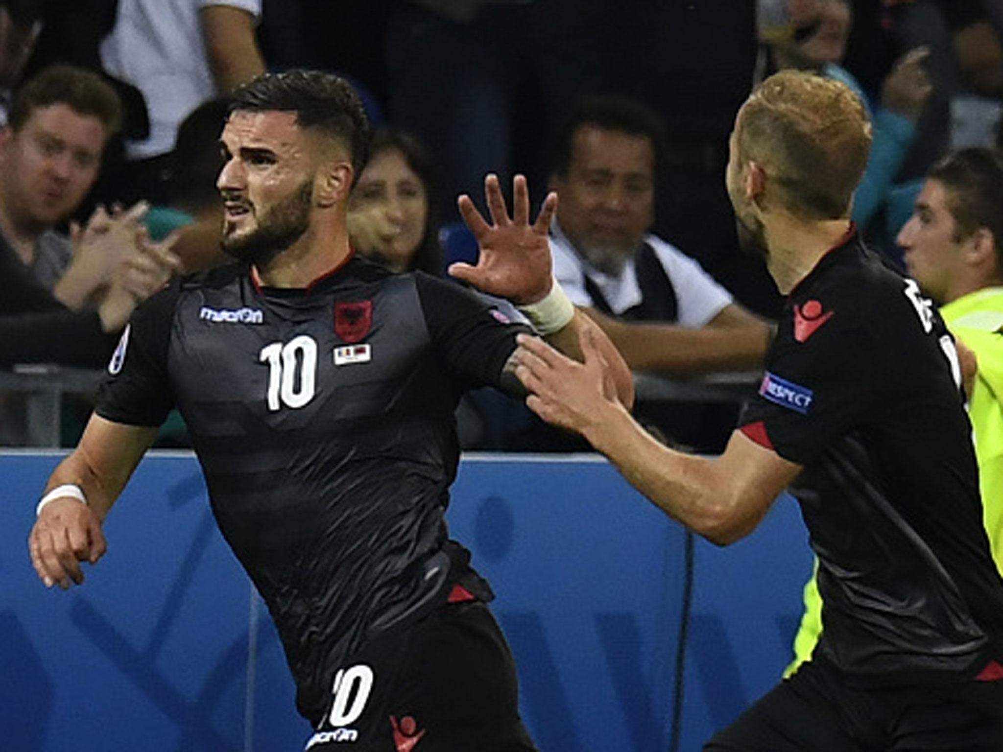 &#13;
Armando Sadiku races off to celebrate his looping header with the Albania bench (Getty)&#13;