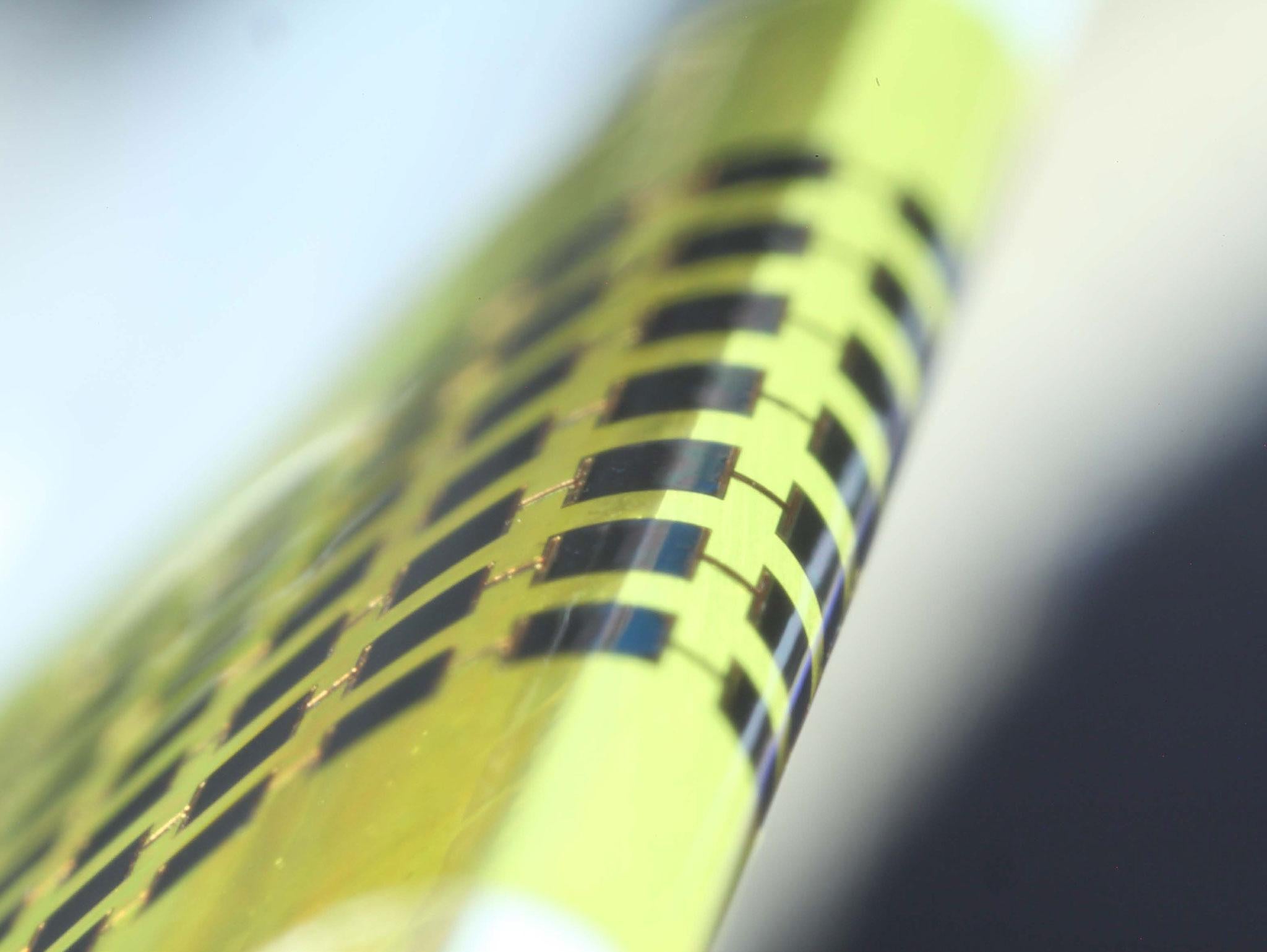 Ultra-thin solar cells are flexible enough to bend around small objects, such as the 1 mm-thick edge of a glass slide.