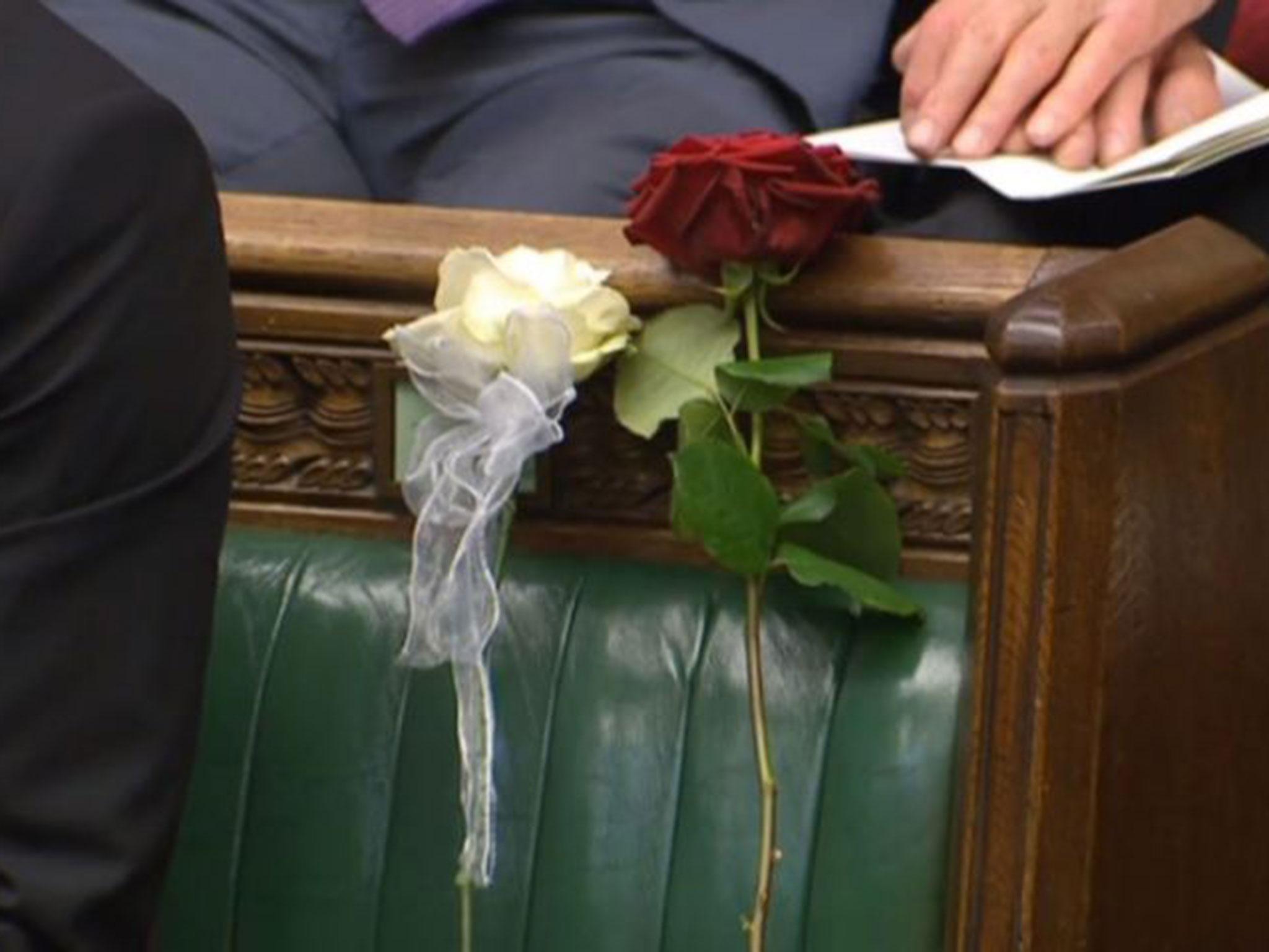A white and red rose lie on Jo Cox's empty seat in the House of Commons, as MPs gather to pay tribute to her