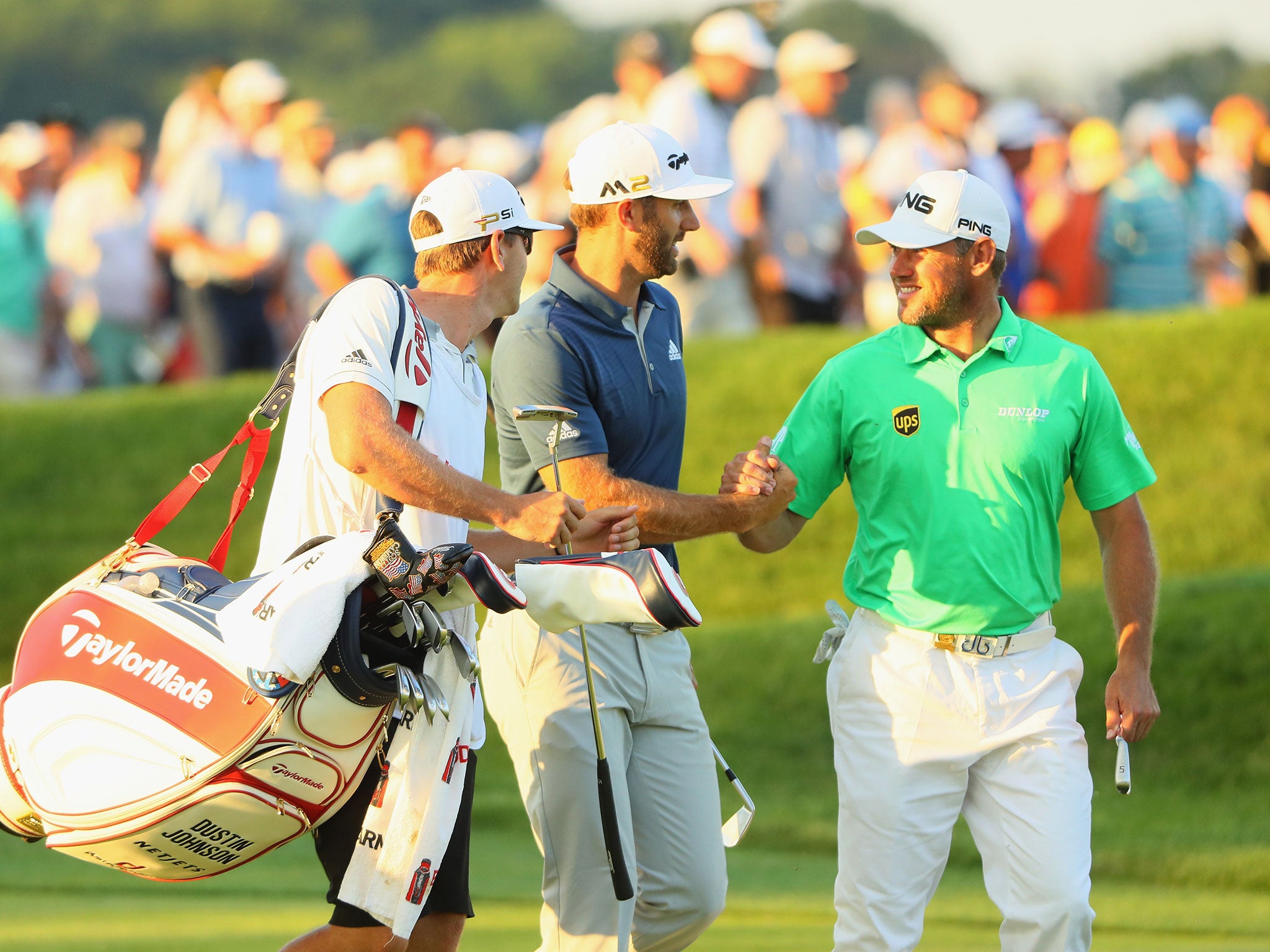 Lee Westwood congratulates Dustin Johnson on the 18th fairway at the US Open on Sunday night at Oakmont