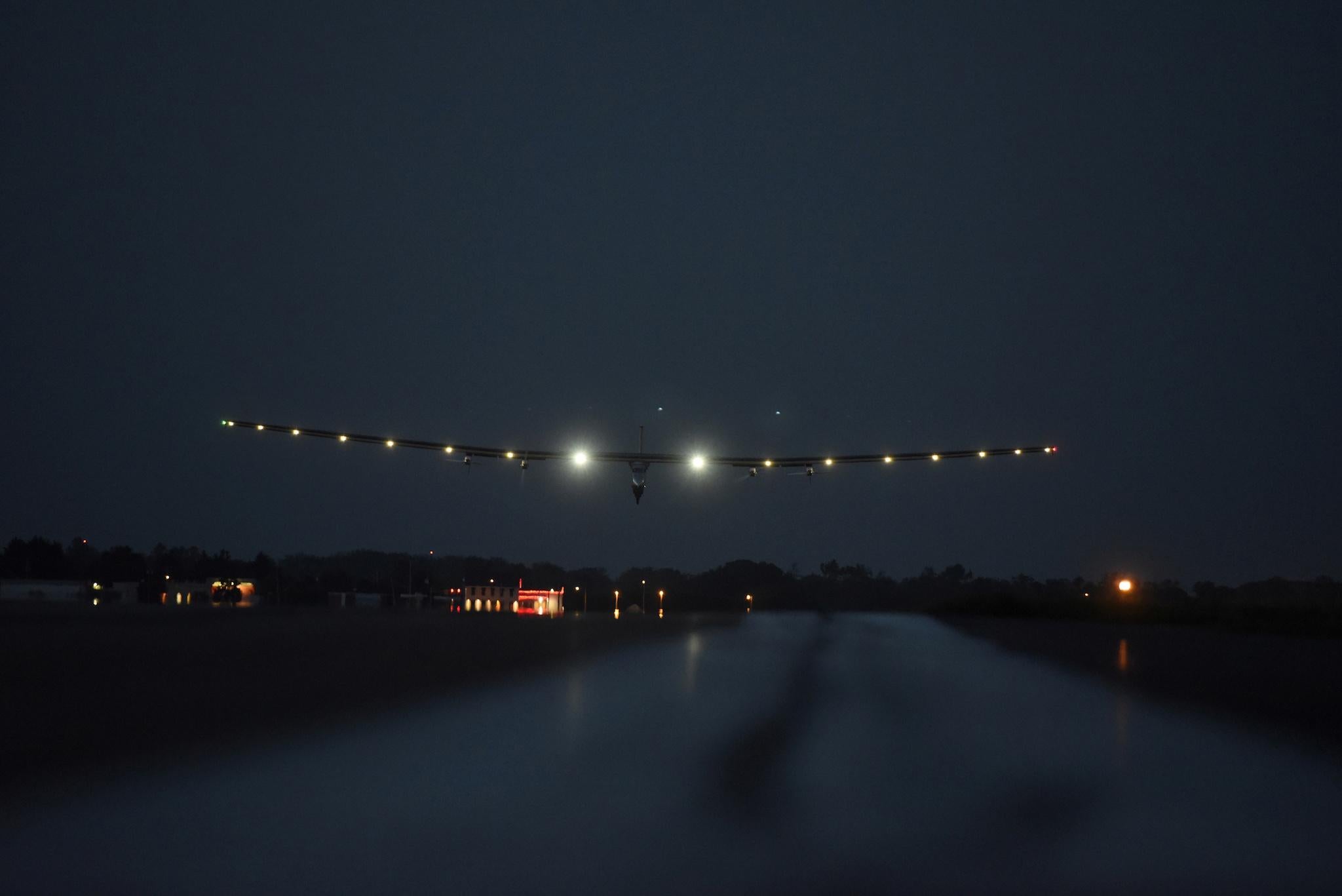 The solar powered airplane Solar Impulse 2 with Bertrand Piccard at the controls is seen landing at Lehigh Valley International Airport