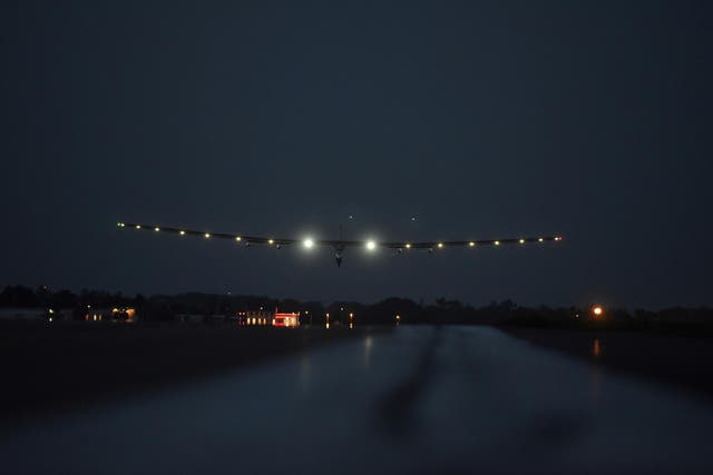 The solar powered airplane Solar Impulse 2 with Bertrand Piccard at the controls is seen landing at Lehigh Valley International Airport