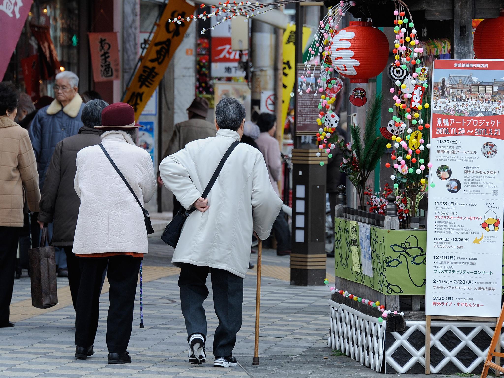 File. Elderly people walk in the street at Kouganji Temple in Tokyo, Japan