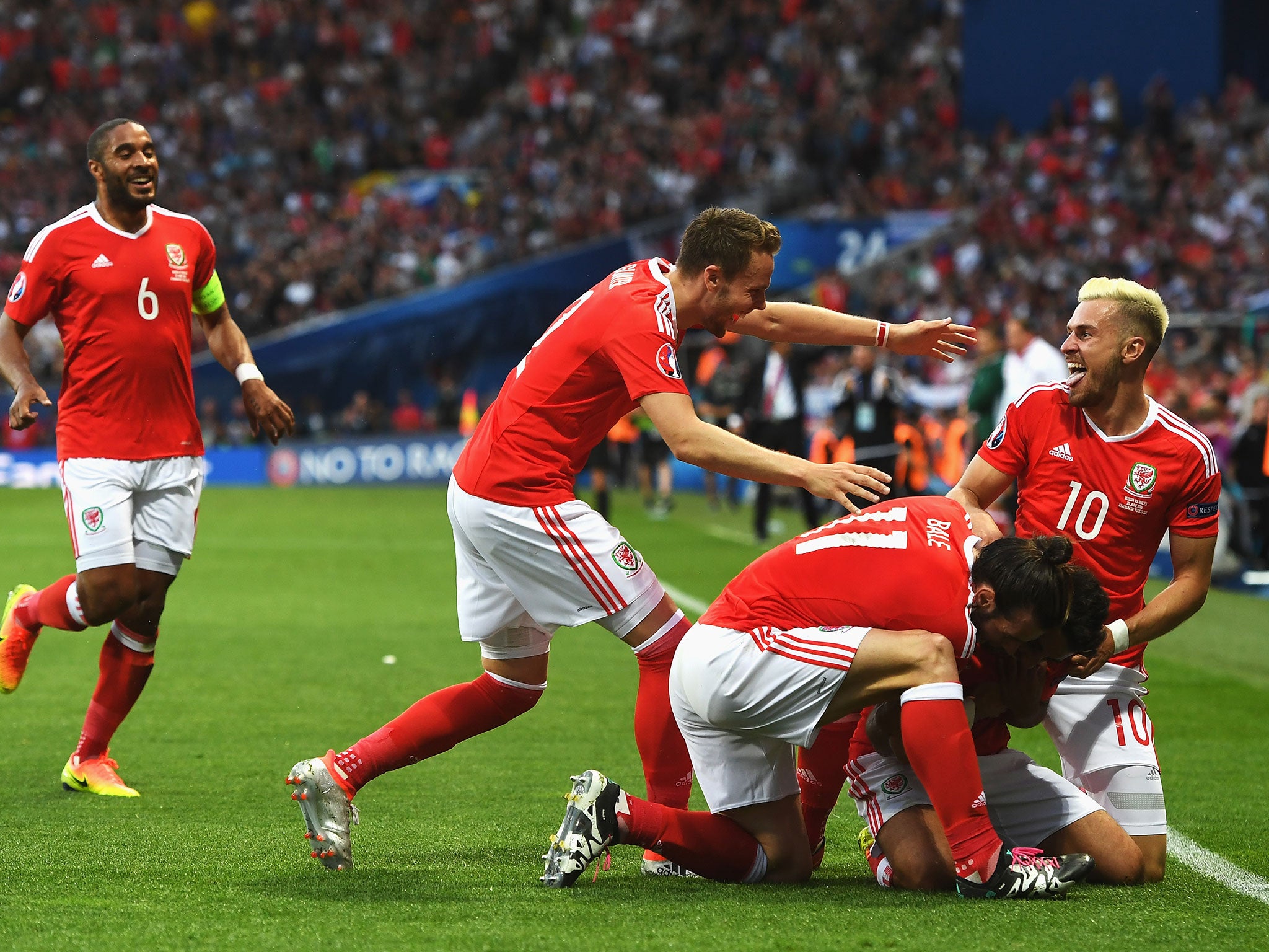 Neil Taylor is congratulated for his goal against Russia