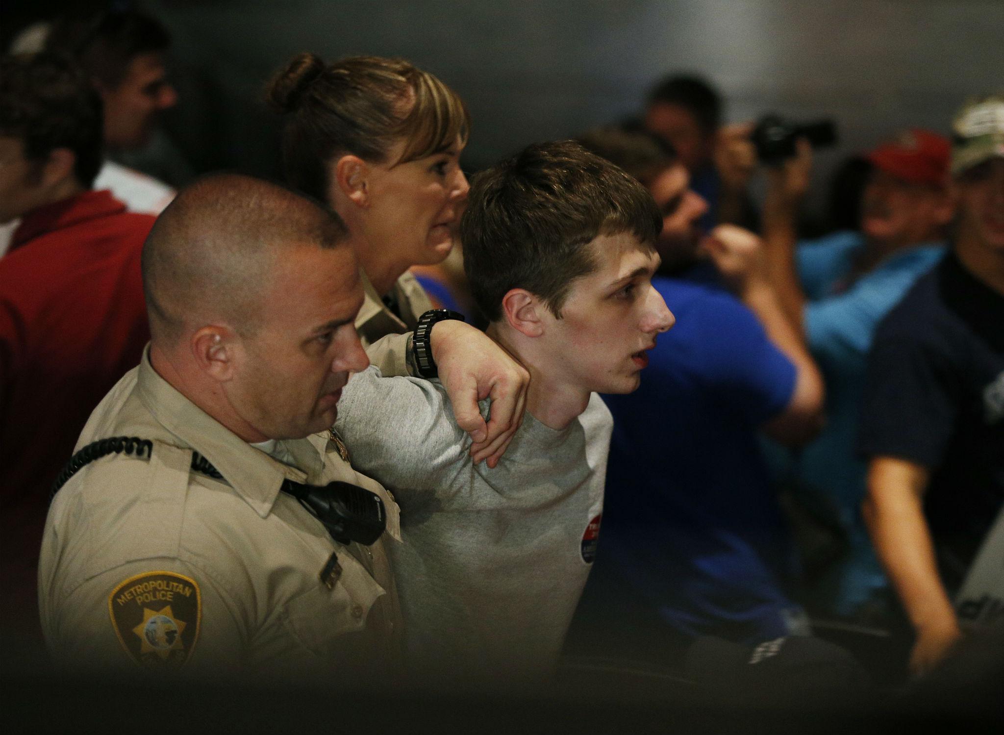 Michael Sandford is removed by police from a Donald Trump rally at the Treasure Island casino in Las Vegas on Saturday 18 June