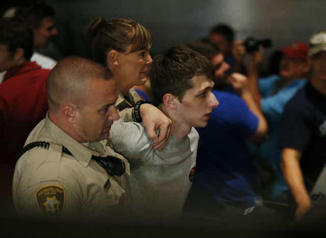 Michael Sandford is removed by police from the Trump rally in Las Vegas in June