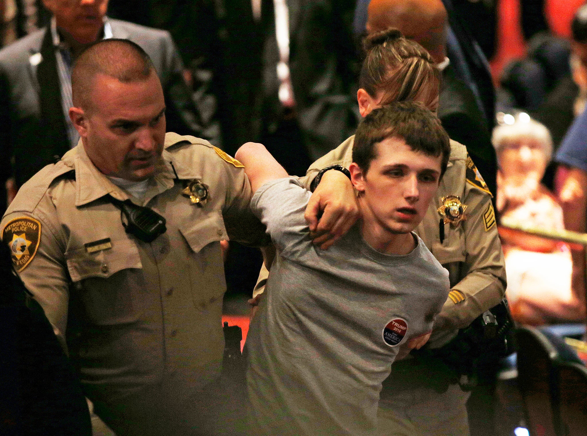 Police remove Michael Steven Sandford as Republican presidential candidate Donald Trump speaks at the Treasure Island hotel and casino in Las Vegas