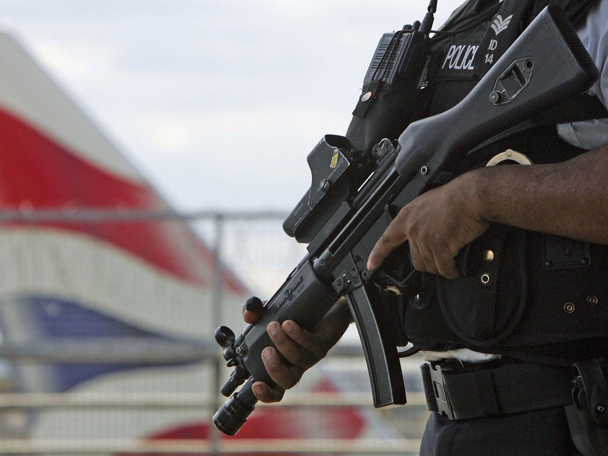 An armed British police officer patrols outside of Heathrow Airport on 11 August, 2006 in London, England