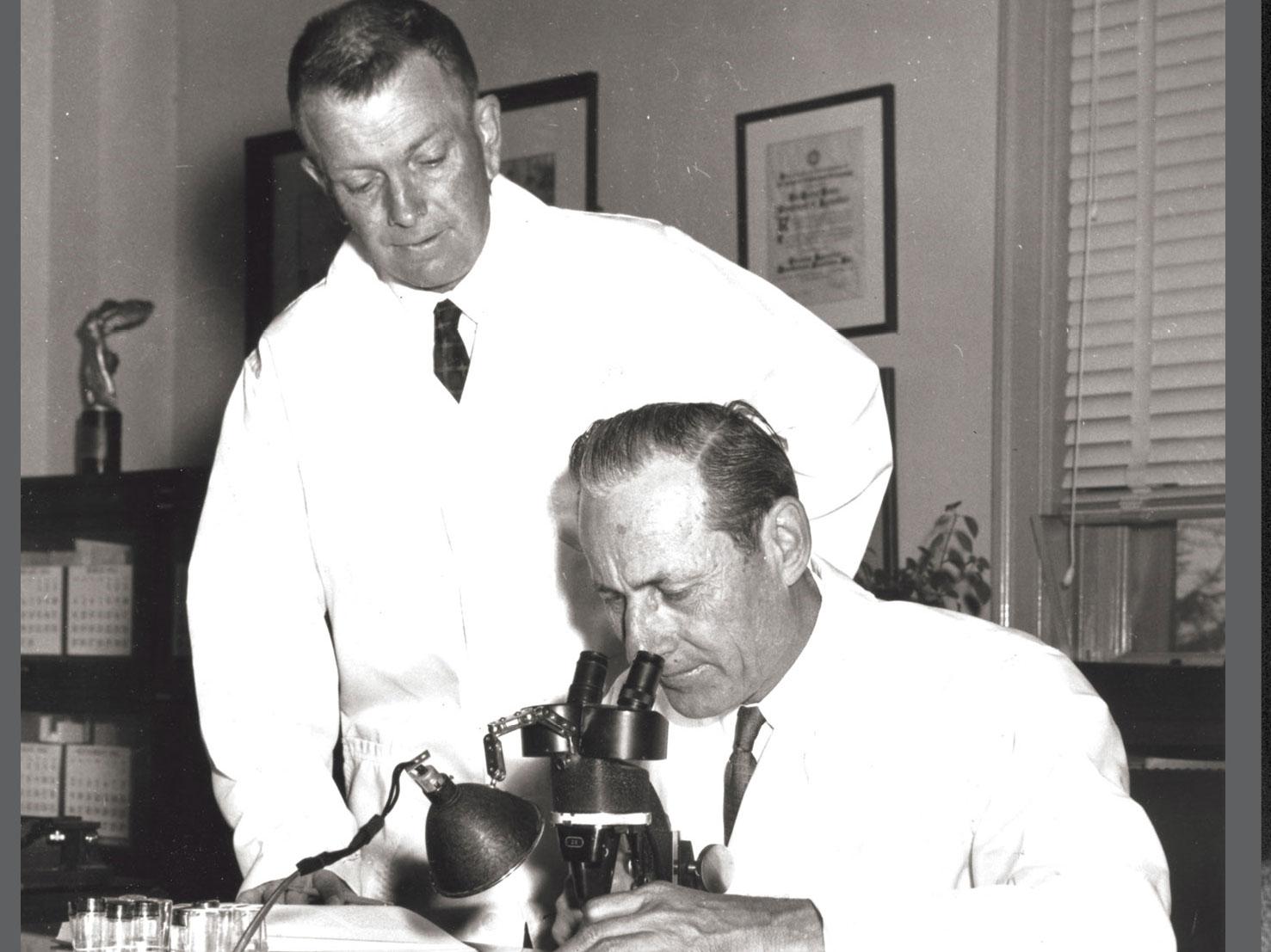 Dr Raymond Bushland (standing) and Dr Edward Knipling