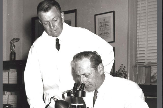 Dr Raymond Bushland (standing) and Dr Edward Knipling