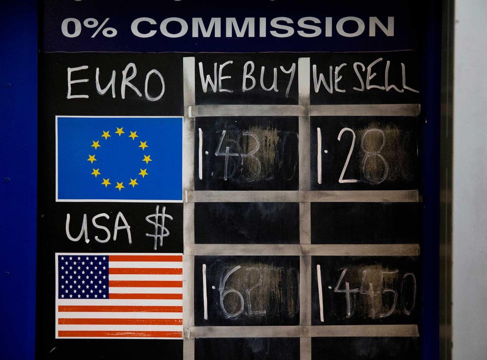 A chalk board shows currency exchange rates at a Bureau de Change in London