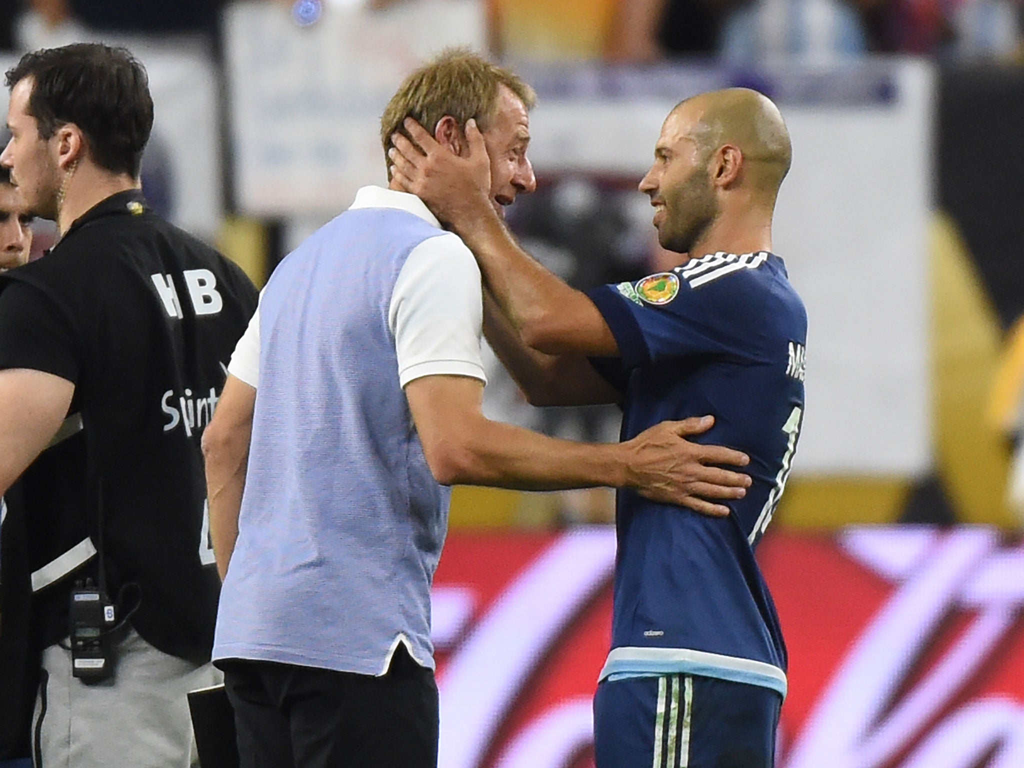 US coach Jurgen Klinsmann speaks to Argentina's Javier Mascherano after the Copa America semi-final