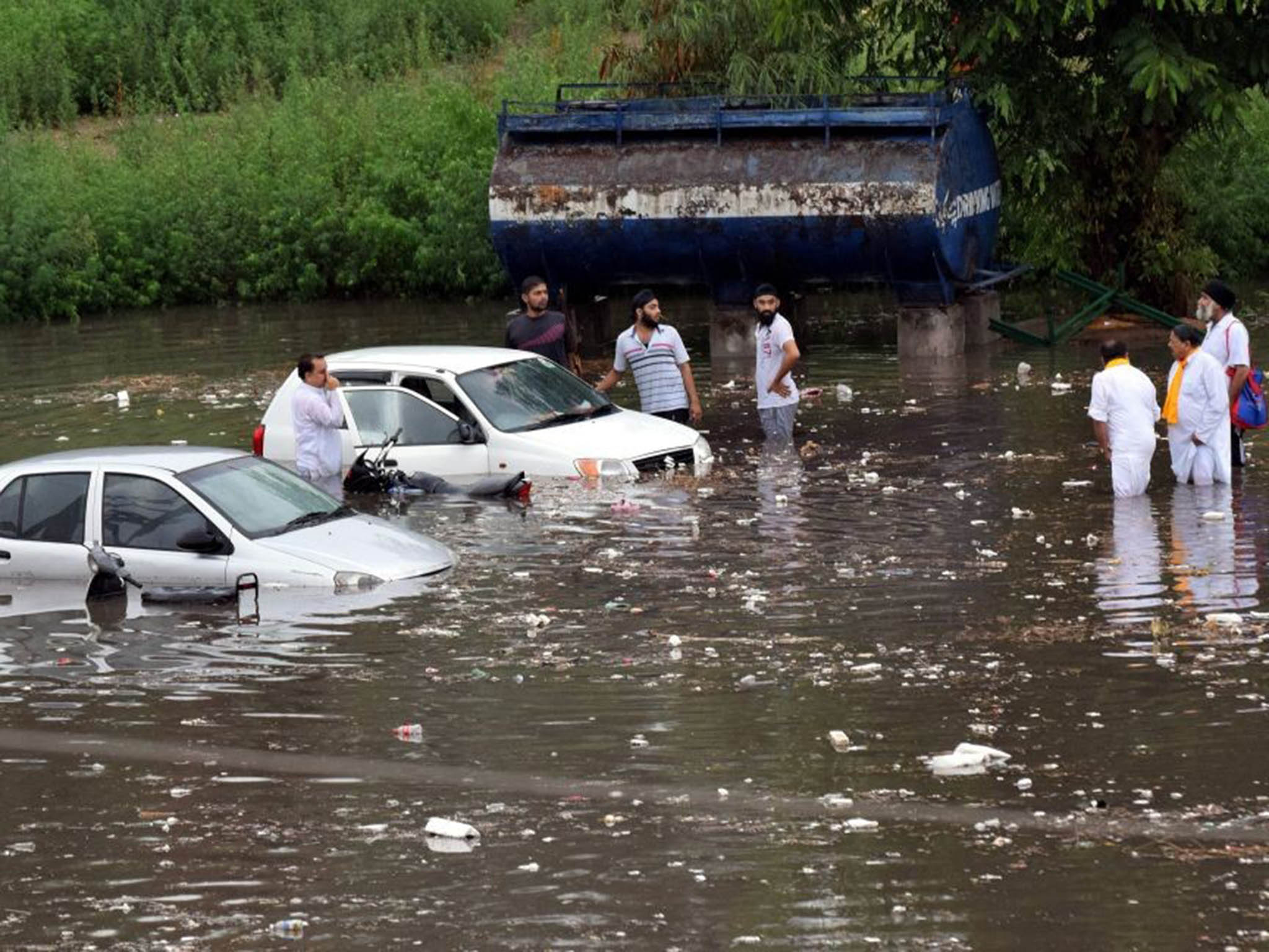 Drowned vehicles after a monsoon shower at the Maulana Azad Stadium in Jammu